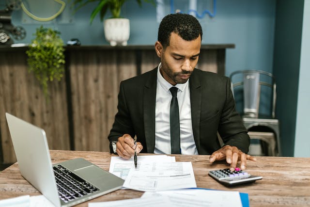 accountant%20looking%20at%20balance%20sheets%20and%20using%20a%20calculator accountant%20looking%20at%20balance%20sheets%20and%20using%20a%20calculator